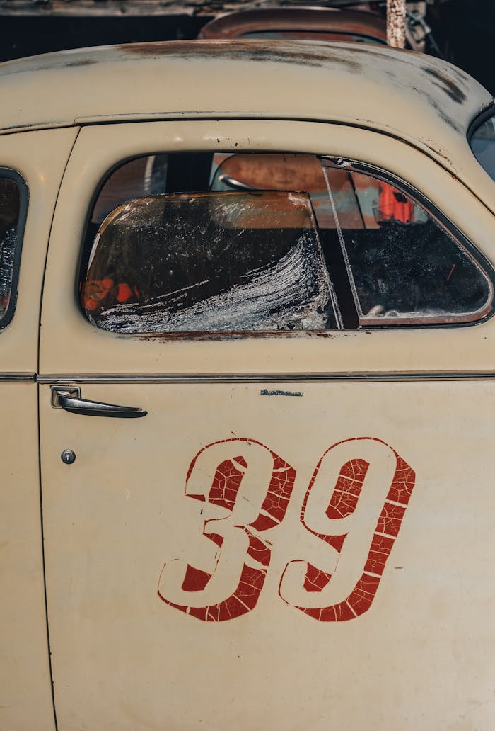 Close-up of a vintage car featuring number 39 on its door, capturing its rustic appeal.